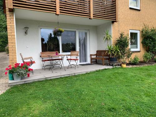 a patio with chairs and a table on a house at Güneitzblick in Clenze