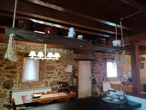 a kitchen with a sink and a table in a room at Casa Rural Alto Santiago in Santiago del Collado
