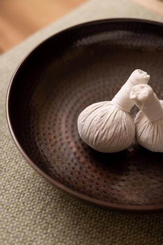 a figurine of a snail sitting on a plate at Inhabit Queen's Gardens, a Member of Design Hotels in London