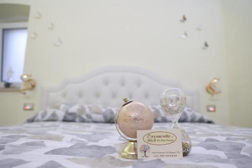 a pair of clocks sitting on top of a bed at C'era Una Volta... in Altamura