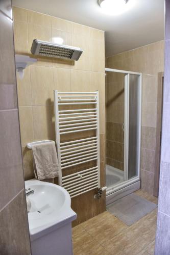 a bathroom with a shower and a toilet and a sink at DORA in Đakovo