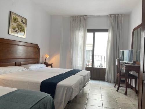 Postel nebo postele na pokoji v ubytování Hotel Al-Andalus
