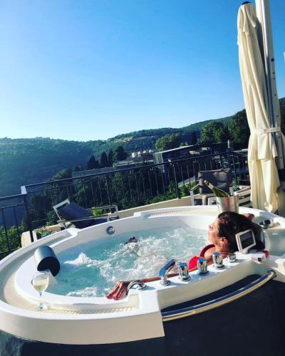 a woman laying in a jacuzzi tub on a resort at Beit Lebbos Boutique Hotel in Beït ed Dîne