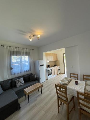 a living room with a blue couch and a table at Elena villa-apartments in Asklipiḯon