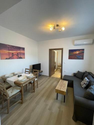 a living room with a couch and a table at Elena villa-apartments in Asklipiḯon