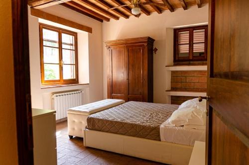 a bedroom with a bed and a window at Podere Mezzastrada - Place of Charme in Fiano