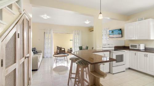 a kitchen with white cabinets and a counter top at Palm View 4 in Watts Village