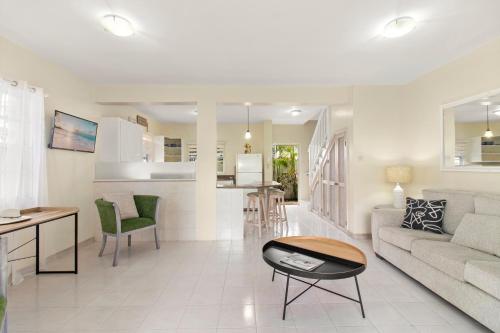 a living room with a couch and a table at Palm View 4 in Watts Village