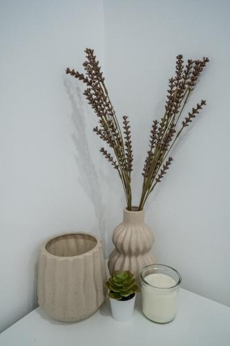 a vase with flowers in it sitting on a shelf at Casas da Barca in Vila Nova de Foz Coa