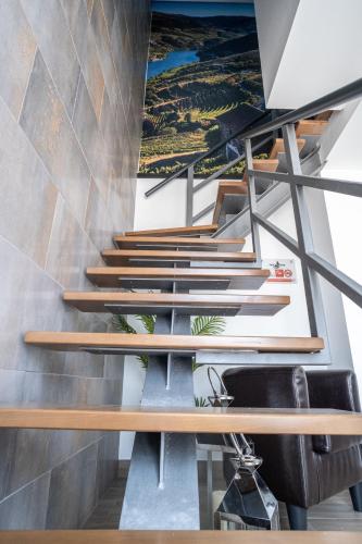 a set of stairs in a room with a sink at Casas da Barca in Vila Nova de Foz Coa