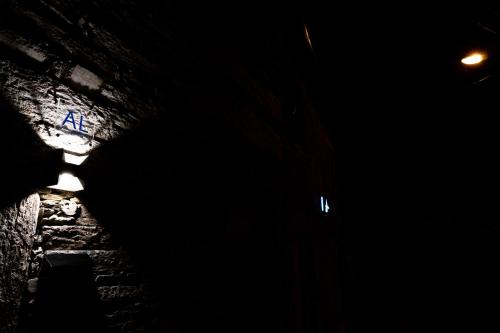 a dark room with a sign in the dark at Casas da Barca in Vila Nova de Foz Coa
