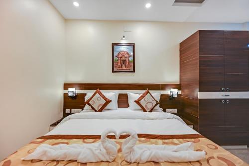 two swans towels on a bed in a bedroom at HOTEL SJ PRIDE in Bhubaneshwar