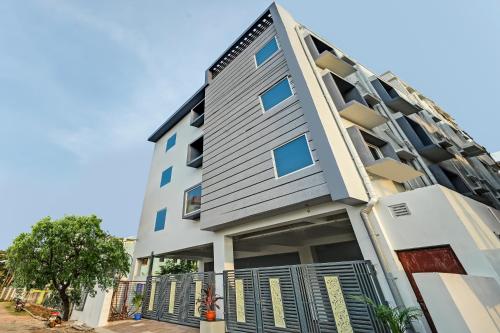 an apartment building with a fence in front of it at HOTEL SJ PRIDE in Bhubaneshwar
