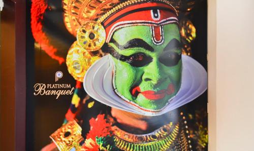 a poster of a woman wearing a green mask at Itsy Hotels Platinum Inn in Chacka