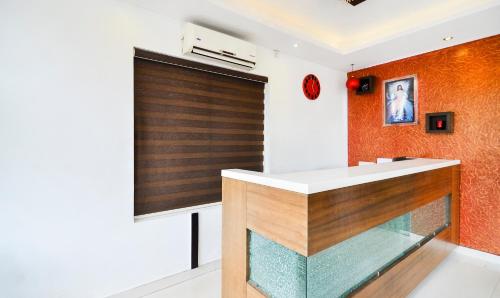 an orange and white kitchen with a glass counter top at Itsy Hotels Platinum Inn in Chacka