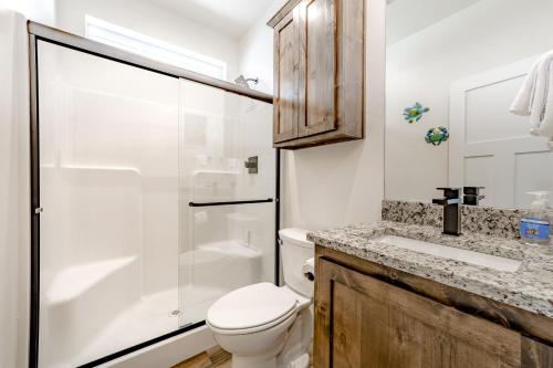 a bathroom with a toilet and a shower and a sink at Porters Paradise in Gold Beach