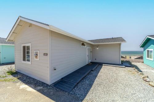 a small white garage with stairs leading into it at Porters Paradise in Gold Beach