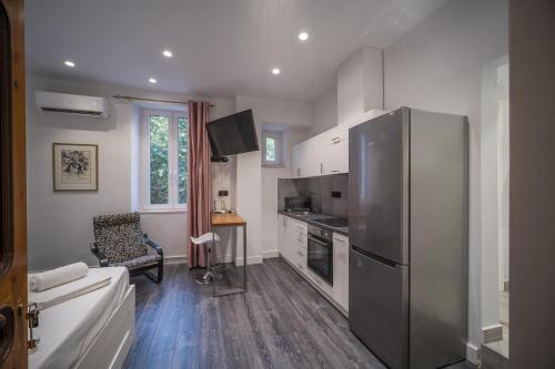 a kitchen with a stainless steel refrigerator and a sink at Studio Reale Corfu in Corfu