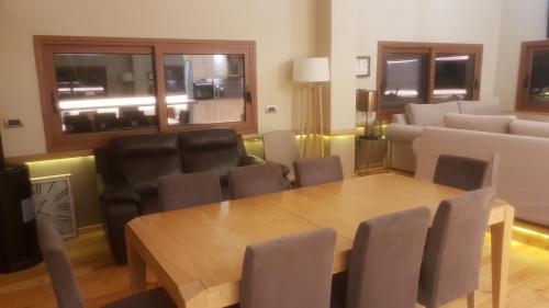 a dining room with a table and leather chairs at Vila Thailanda in Katakolo in Pýrgos
