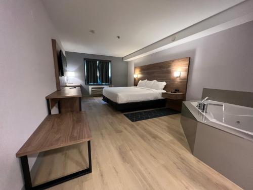 a hotel room with a bed and a sink at Super 8 by Wyndham Cornwall ON in Cornwall