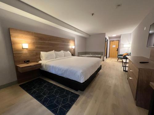 a hotel room with a bed and a desk at Super 8 by Wyndham Cornwall ON in Cornwall