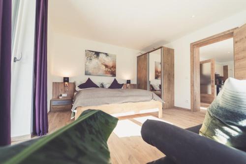 a bedroom with a bed and a large mirror at Apartments z‘Haus in Sankt Gilgen