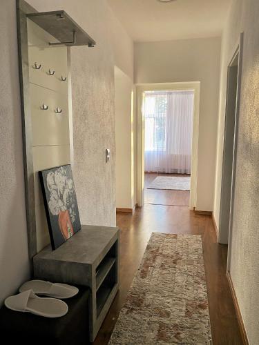 a living room with a bench and a mirror at Cozy Apartment Bernburg 1 in Roschwitz