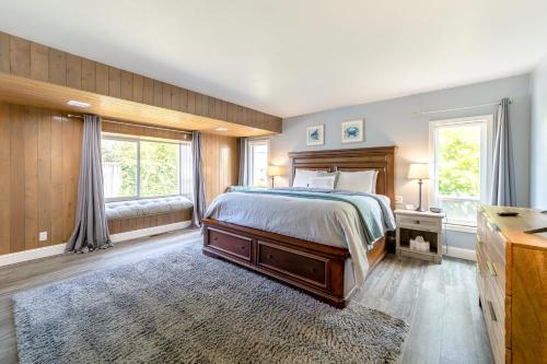a bedroom with a bed and a large window at Ocean View Retreat in Brookings