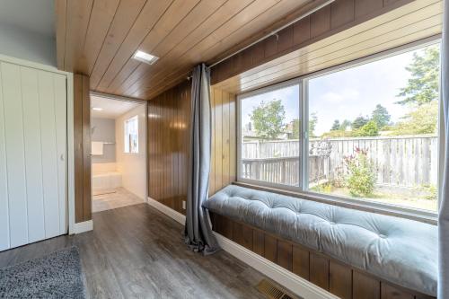 a room with a large window and a couch at Ocean View Retreat in Brookings