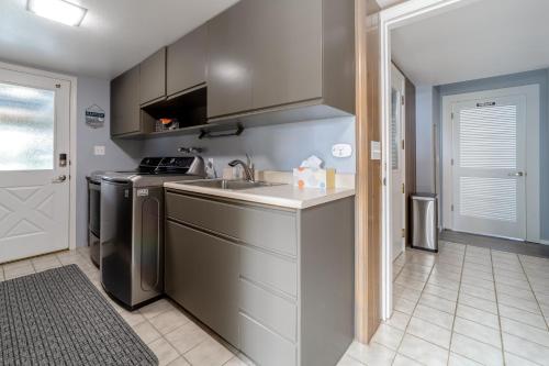 a kitchen with a sink and a dishwasher at Ocean View Retreat in Brookings