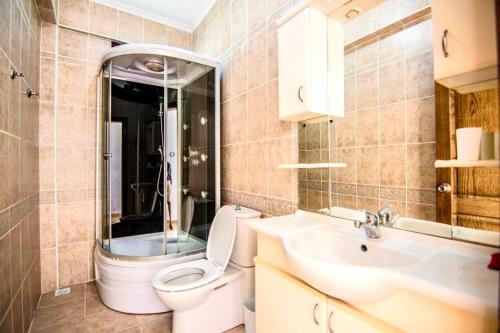 a bathroom with a toilet and a sink at Villa Mor Fethiye in Fethiye