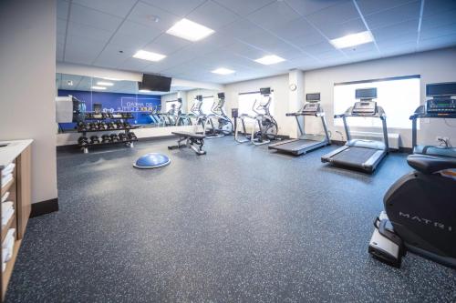 a gym with several treadmills and exercise machines at Holiday Inn Express and Suites Atlanta-Johns Creek by IHG in Johns Creek