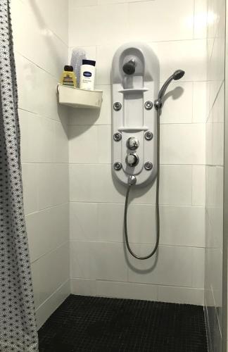 a shower with a shower head in a bathroom at Ocean House in Santa Cruz