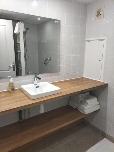 une salle de bain avec un lavabo et un miroir dans l'établissement Promenade résidence hoteliére, à Nice