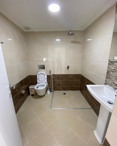 a bathroom with a toilet and a sink at Gerard apartments in Sarandë