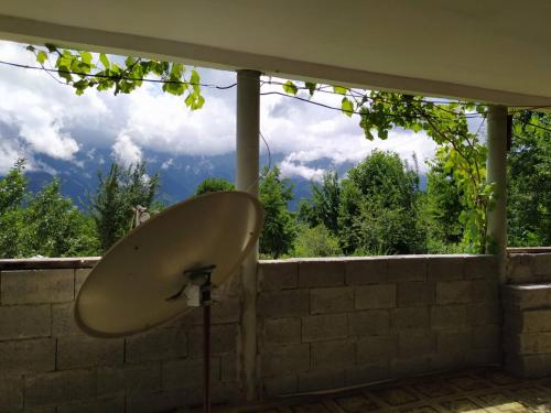 a bath tub sitting on top of a brick wall at Gujejiani Guest house in Mestia