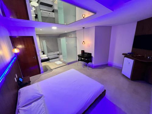 um quarto com uma cama e uma secretária num quarto em Bliss Motel em Brasília