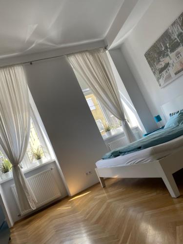 una camera con un letto e due finestre di Cozy city apartment near city center a Vienna