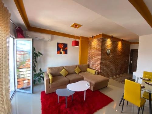 a living room with a couch and a table at Your Apartment in Pogradec