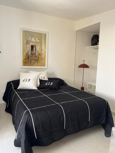a bedroom with a bed with a black blanket at Artemide Luxury Home in Syracuse