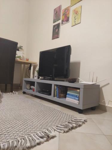 a flat screen tv sitting on a entertainment center at Κλινάρι in Xanthi