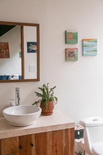 a bathroom with a sink and a mirror at El Hábita CASA MAR in Santa Teresa Beach