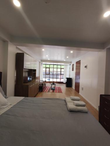 a bedroom with a large bed with two towels on it at Casa Agustina in Cusco
