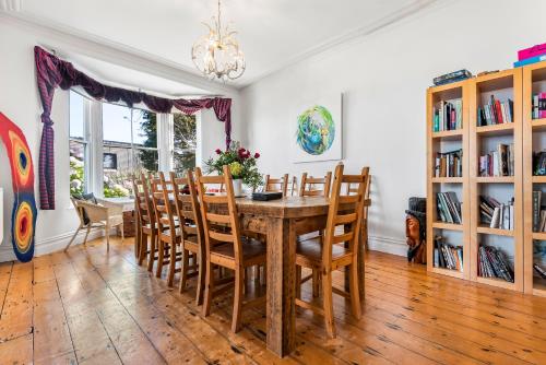 a dining room with a wooden table and chairs at organic panda in St Ives