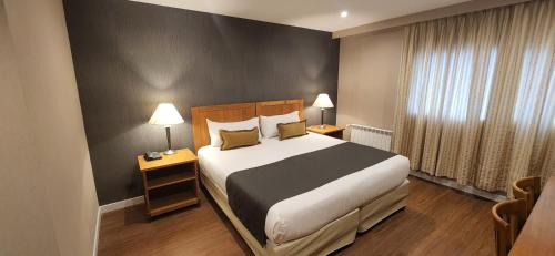 Cama ou camas em um quarto em Hotel Canal Beagle