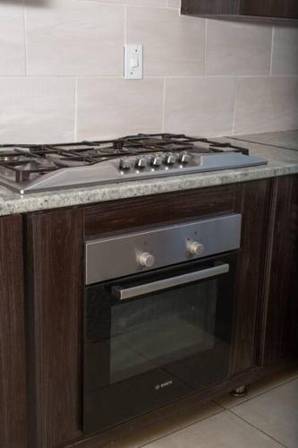 a stove top oven in a kitchen at HomeSweetHome Farm Cottage in Nelspruit