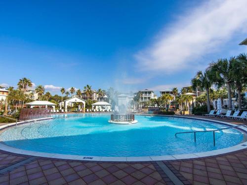 a large swimming pool with a fountain in the middle at The Holland House II in Rosemary Beach