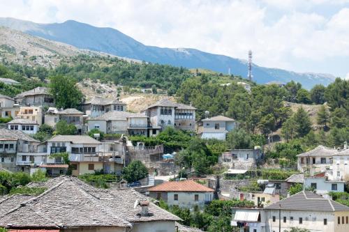 a village in the mountains with houses at KALE GUESTHOUSE in Gjirokastër