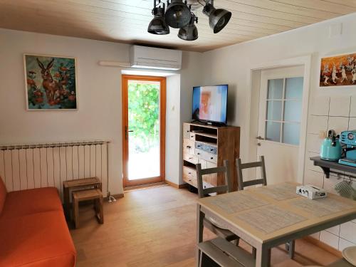 a living room with a table and a television at Pri Zajcu in Bovec