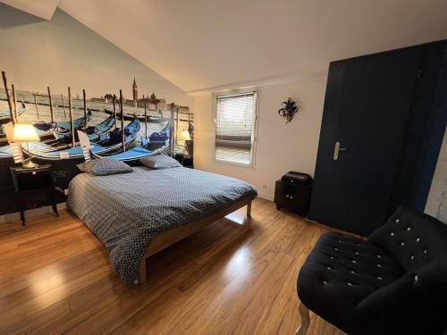 a bedroom with a bed with a boat on the wall at L'escale au Port Miniature de Saint Savinien in Le Mung
